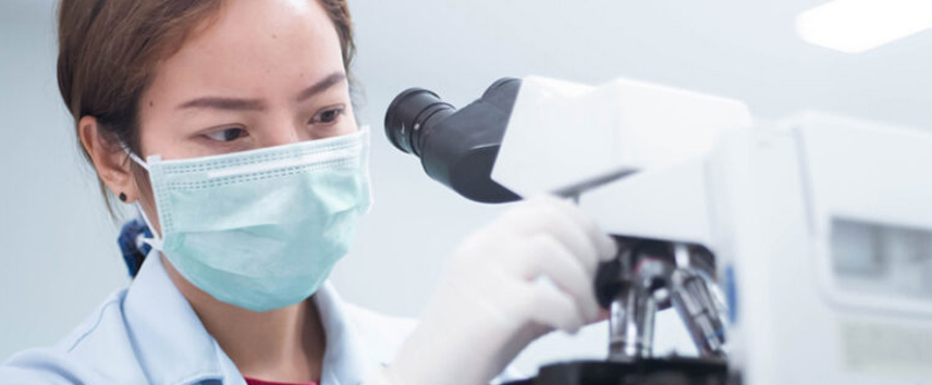 Biopsy, pathologist reviewing tissue under microscope