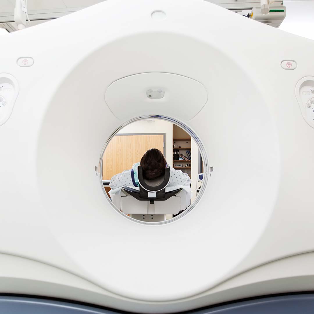1080x1080Social-4 Female patient undergoing CT scan test in examination room